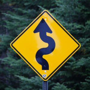 In Focus: Who Is The Release Train Engineer - road sign meaning winding road ahead
